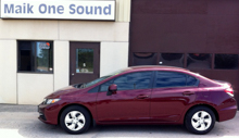 Red 2013 Honda Civic with professional window tint at Maik One Sound